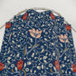 Floral patterned fabric on a metal hanger against a white background