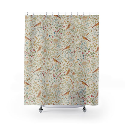 A beige shower curtain with a multicolored floral and bird pattern, inspired by William Morris.
