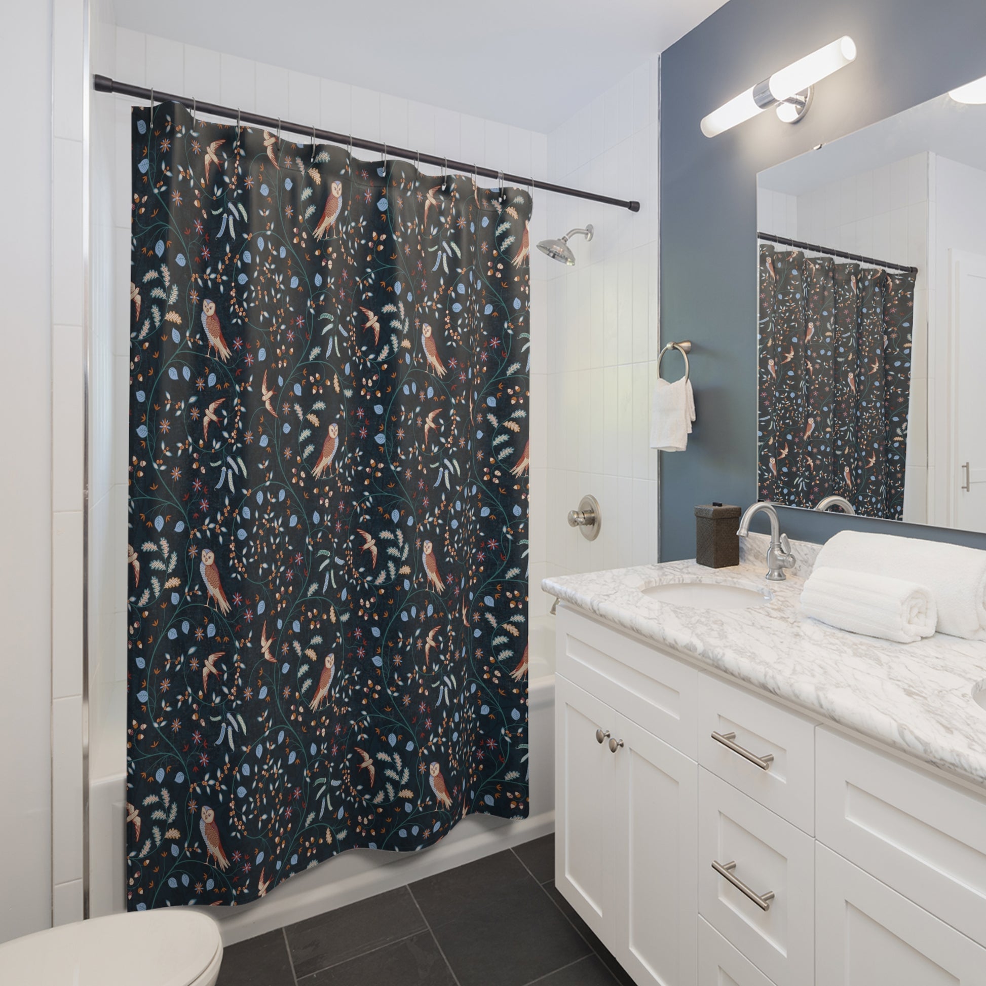 Bathroom with a patterned shower curtain, white vanity, and mirror.