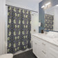 Bathroom with a floral-patterned shower curtain, white vanity, and mirror.
