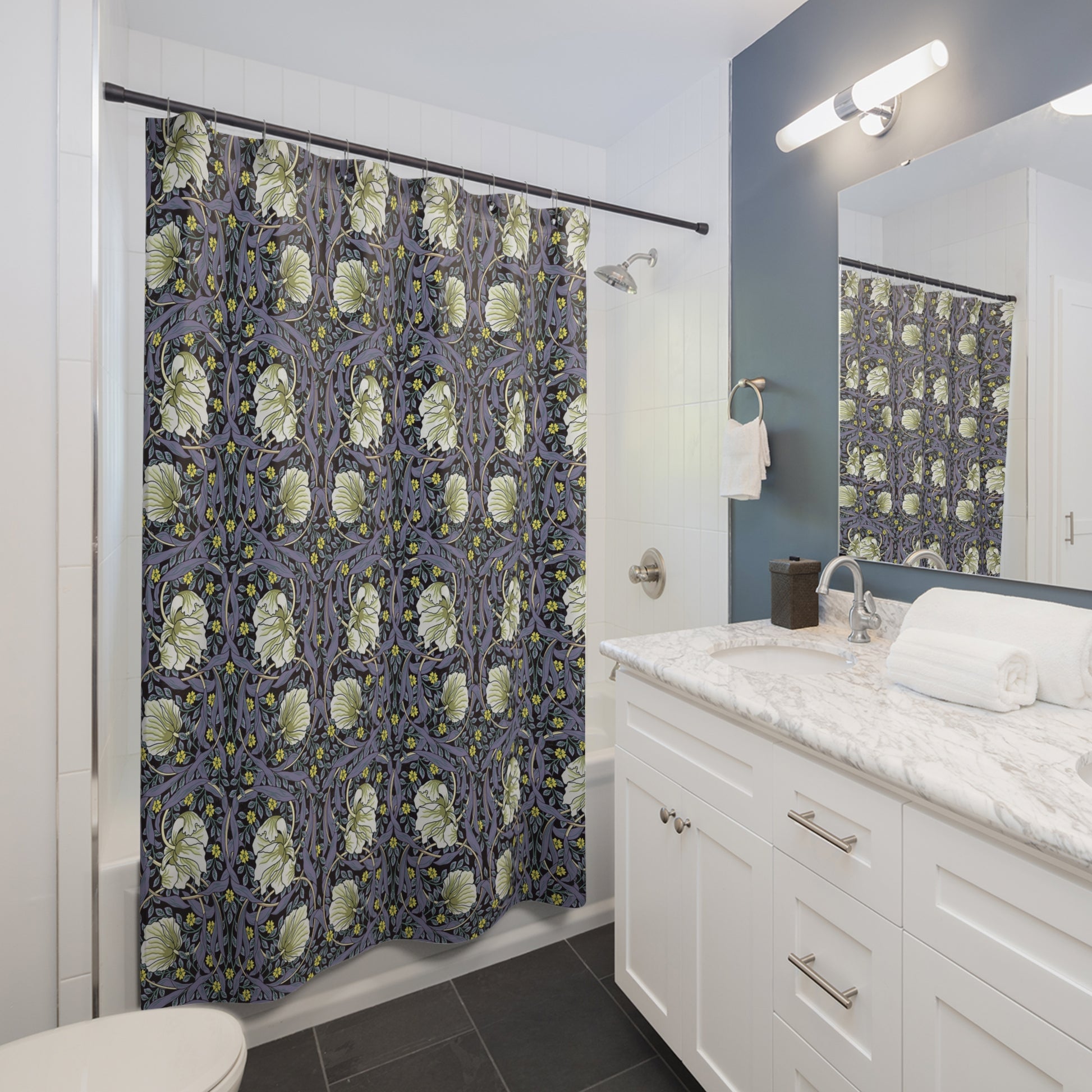 Bathroom with a floral-patterned shower curtain, white vanity, and mirror.