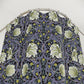 Floral patterned shirt on a hanger against a white background