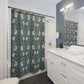 Bathroom with a floral shower curtain, white vanity, and mirror.