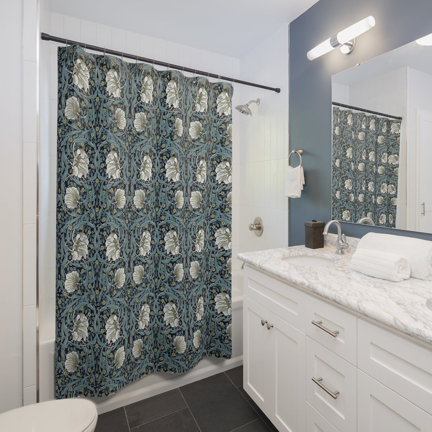 Bathroom with a floral shower curtain, white vanity, and mirror.