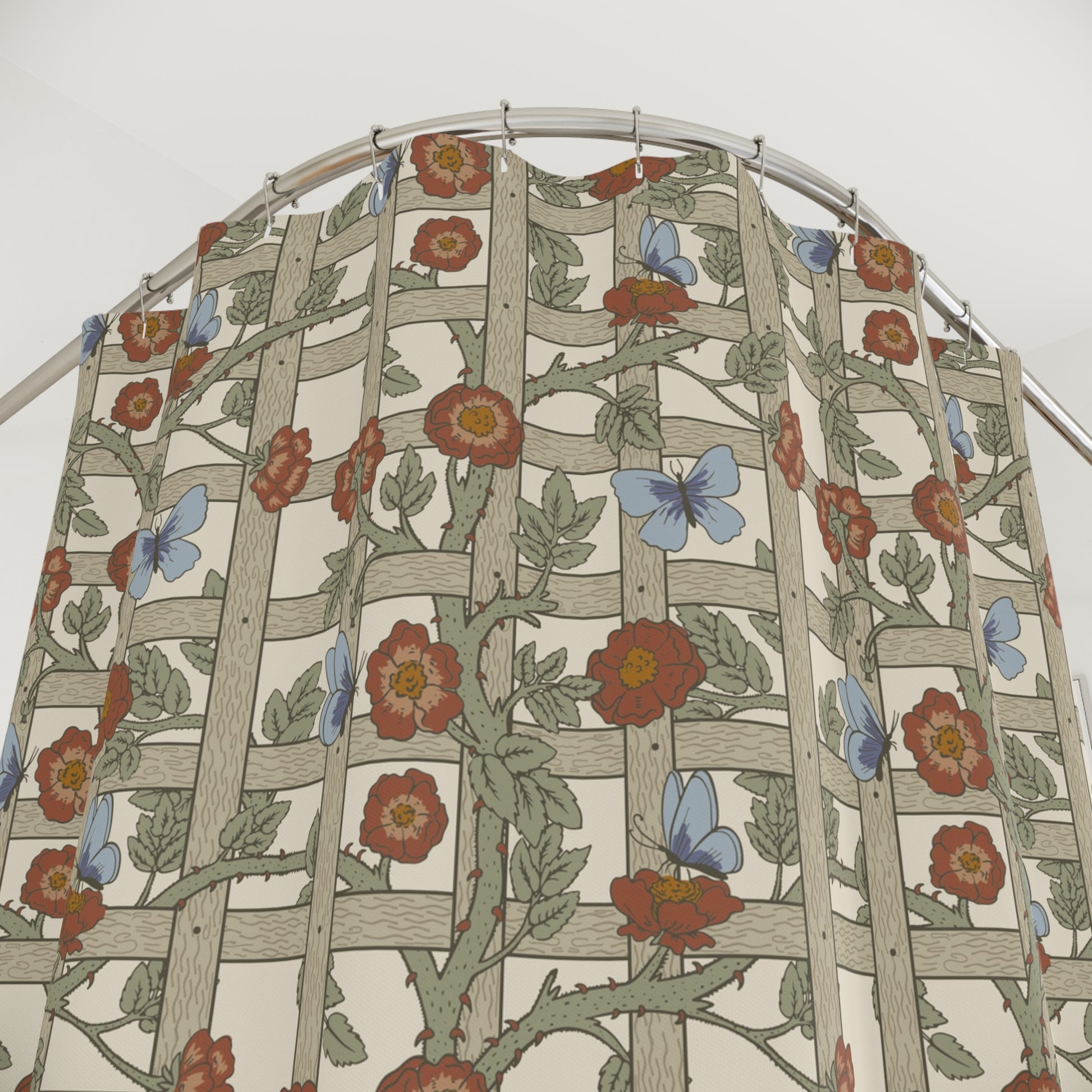 A shower curtain with a geometric William Morris & Co pattern featuring floral elements in beige, red, and blue colours on a white background.