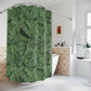 Green leaf-patterned shower curtain in a bathroom setting