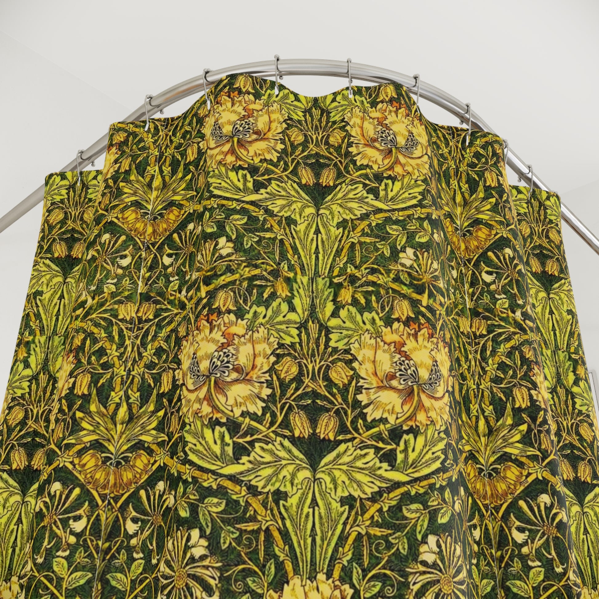 A shower curtain with a gold and green floral pattern inspired by the Victorian era and the art of William Morris.