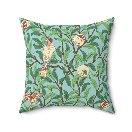A square-shaped throw pillow with a Tiffany Blue floral background featuring a bird and pomegranate William Morris & Co pattern .