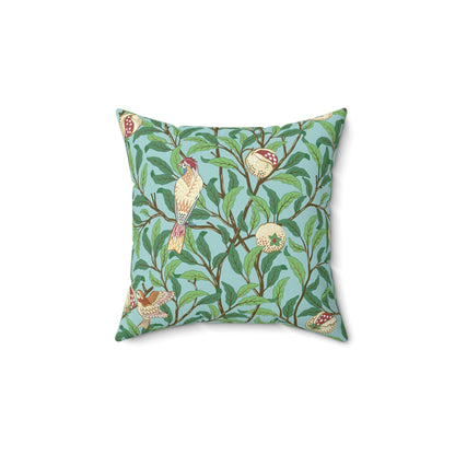 A square-shaped throw pillow with a Tiffany Blue floral background featuring a bird and pomegranate William Morris & Co pattern .