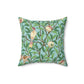 A square-shaped throw pillow with a Tiffany Blue floral background featuring a bird and pomegranate William Morris & Co pattern .