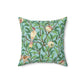 A square-shaped throw pillow with a Tiffany Blue floral background featuring a bird and pomegranate William Morris & Co pattern .