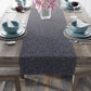 A smoky blue table runner with a William Morris & Co leaf pattern displayed on a dining table.