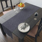 A smoky blue table runner with a William Morris & Co leaf pattern displayed on a dining table.