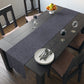 A smoky blue table runner with a William Morris & Co leaf pattern displayed on a dining table.