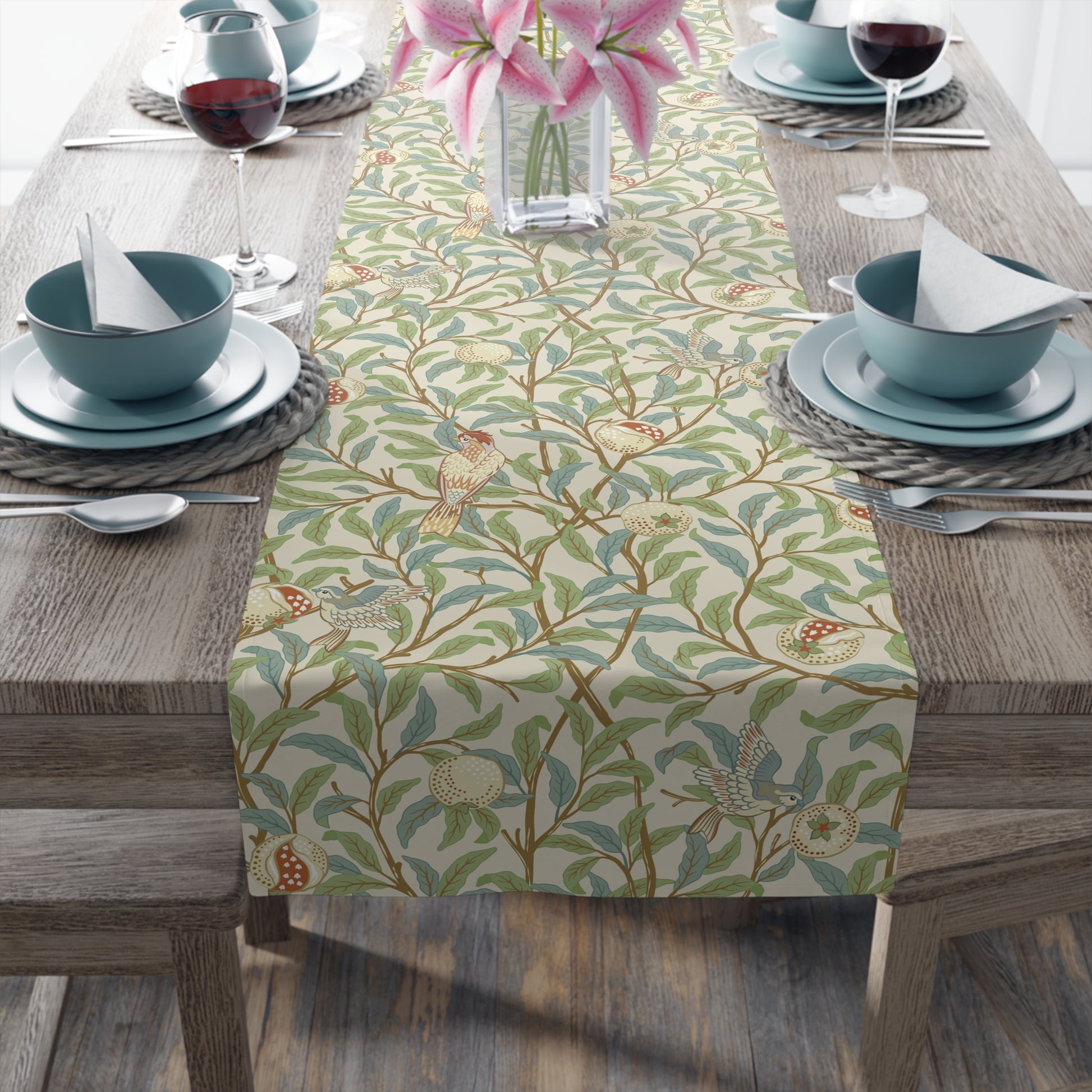 A table runner with a Victorian floral design in green, blue, and brown colors, laid out on a dining table.
