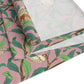 A table runner with a William Morris & Co Victorian-inspired bird and pomegranate pattern laid out on a dining table.