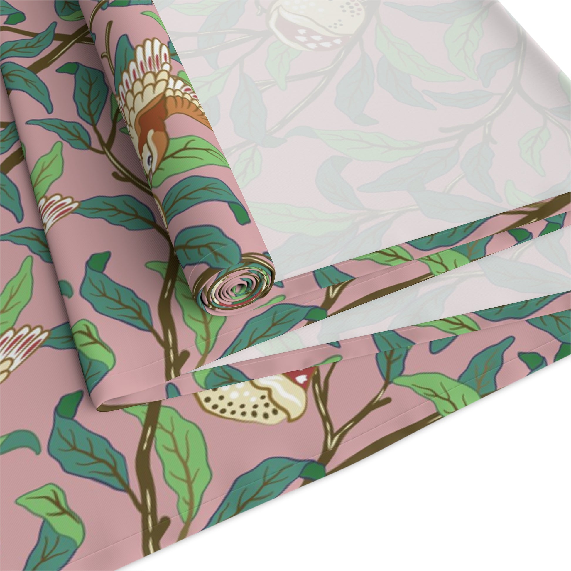 A table runner with a William Morris & Co Victorian-inspired bird and pomegranate pattern laid out on a dining table.