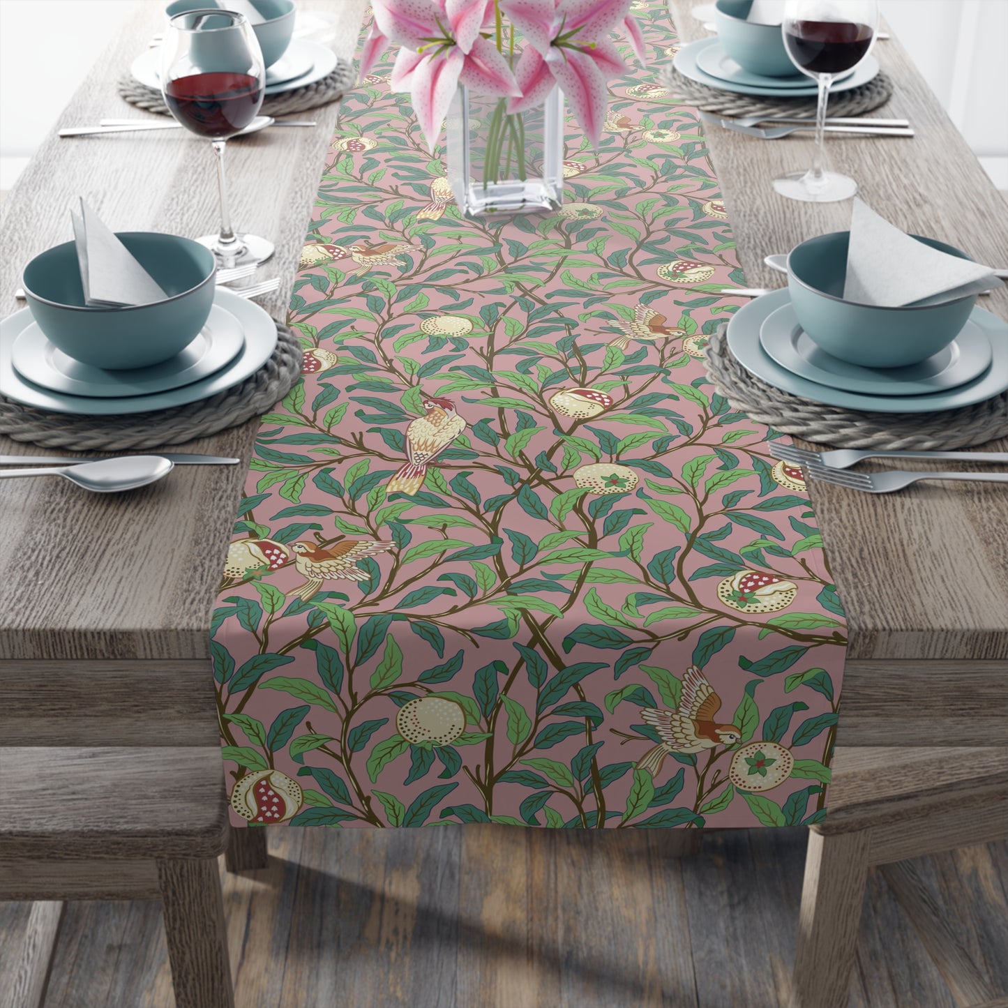 A table runner with a Victorian-inspired bird and pomegranate pattern laid out on a dining table.