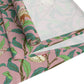 A table runner with a William Morris & Co Victorian-inspired bird and pomegranate pattern laid out on a dining table.