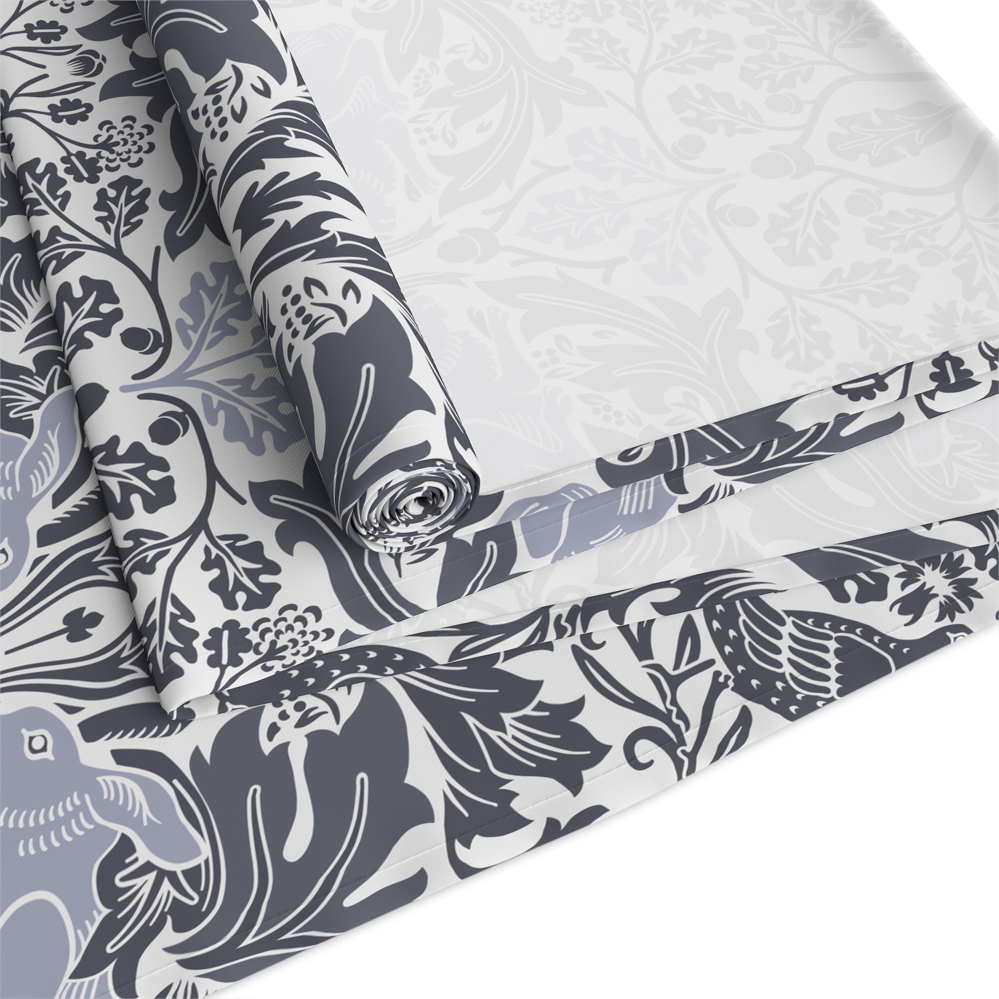 Roll of fabric with a floral and bird pattern on a white background