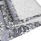 Roll of patterned fabric with blue and white designs on a white background