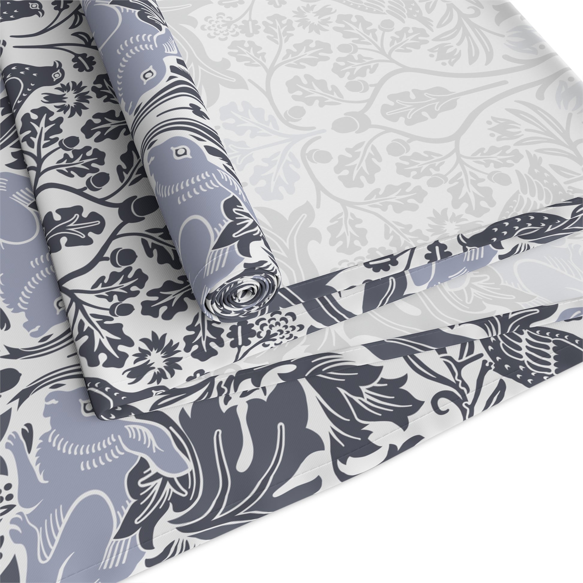 Roll of fabric with blue and white floral and animal pattern