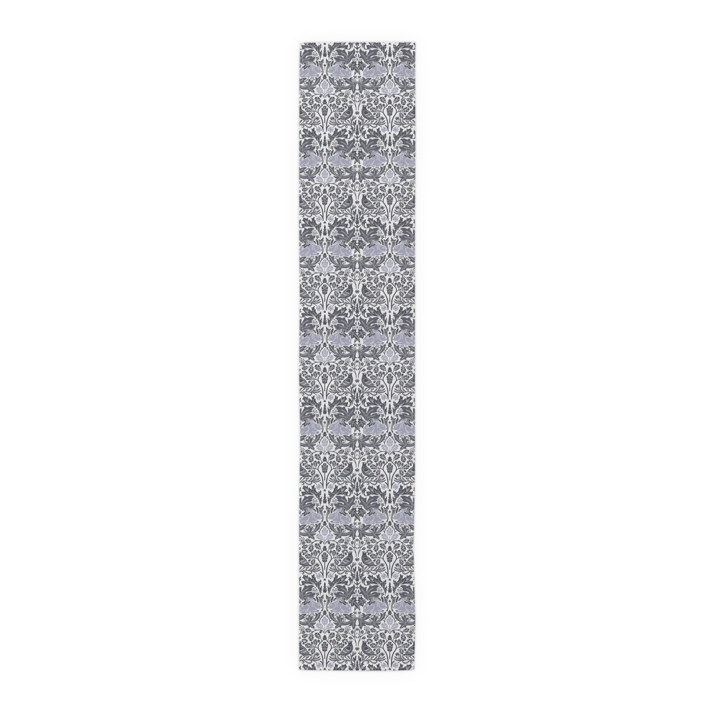Long, narrow rug with a gray and white floral pattern on a white background