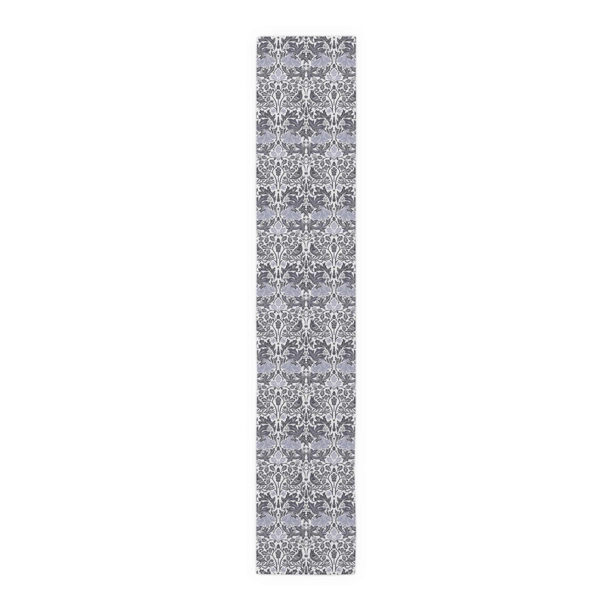 Long, narrow rug with a gray and white floral pattern on a white background