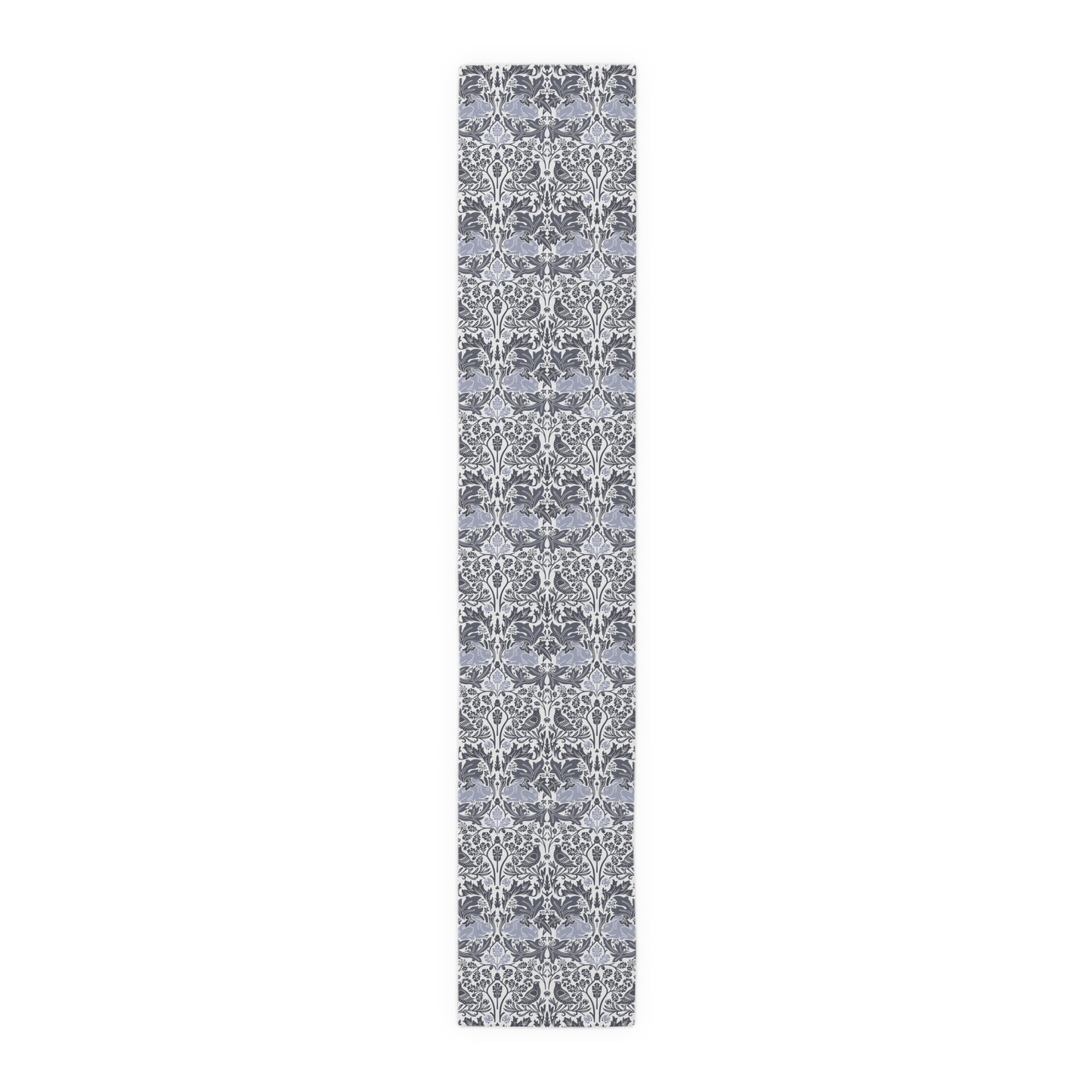 Long, narrow rug with a gray and white floral pattern on a white background