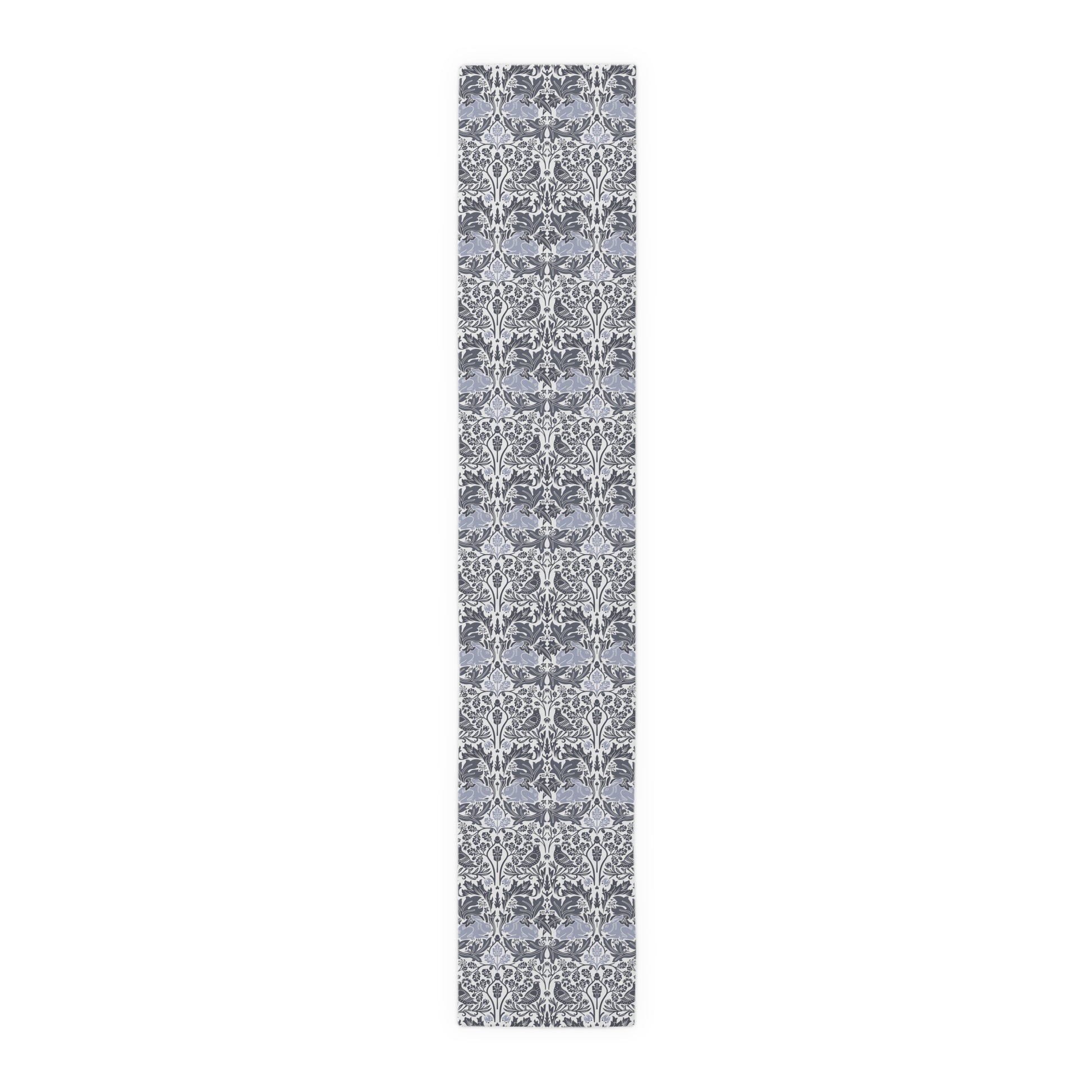 Long, narrow rug with a gray and white floral pattern on a white background