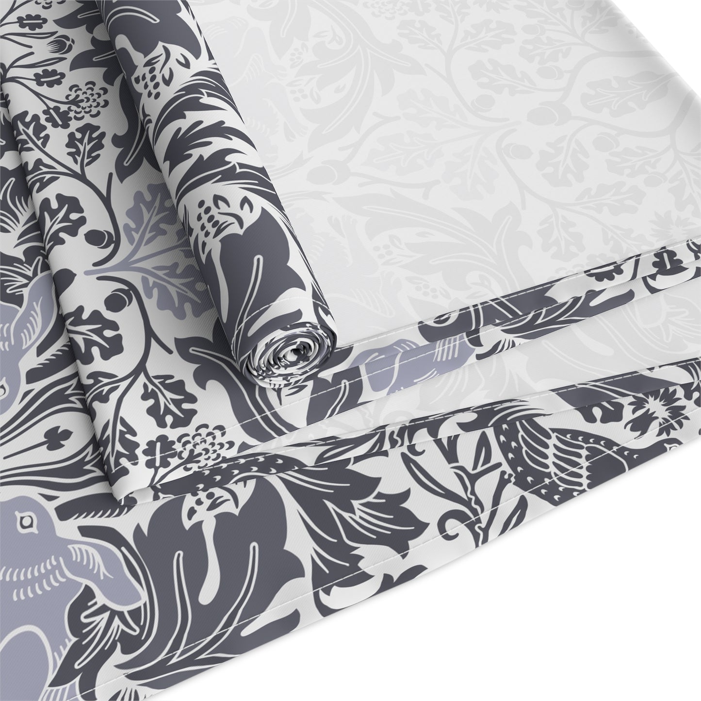 Roll of fabric with a floral and bird pattern on a white background
