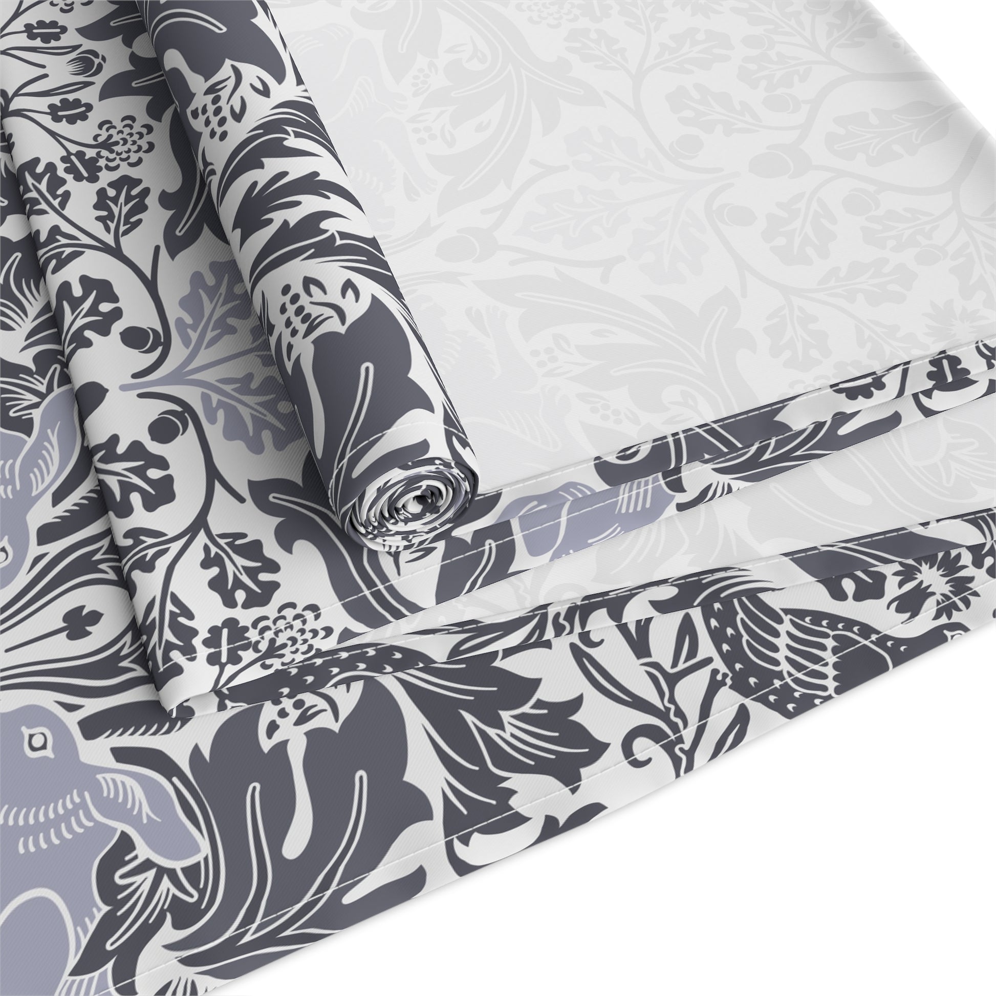 Roll of fabric with a floral and bird pattern on a white background