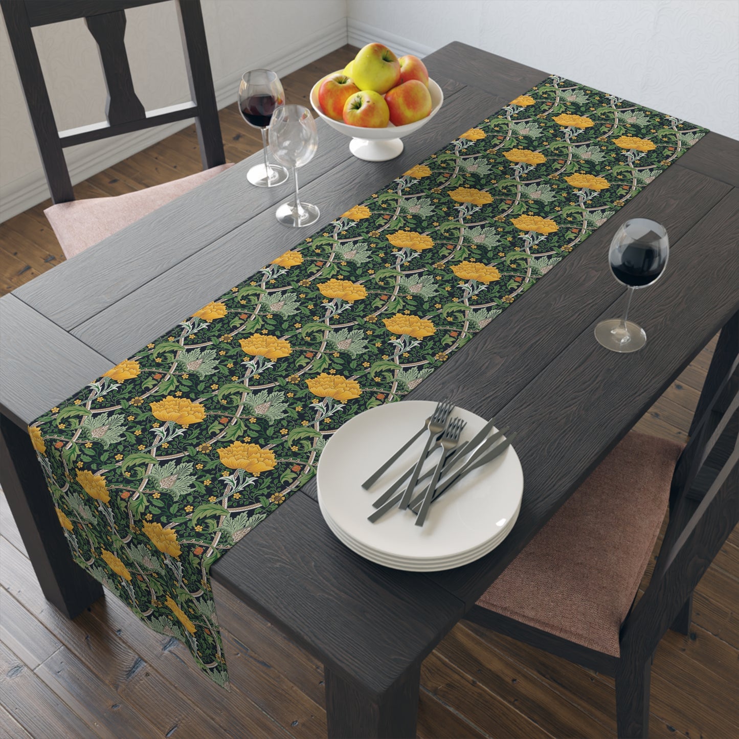 A yellow and green floral William Morris & Co patterned table runner with hemmed edges displayed on a dining table.