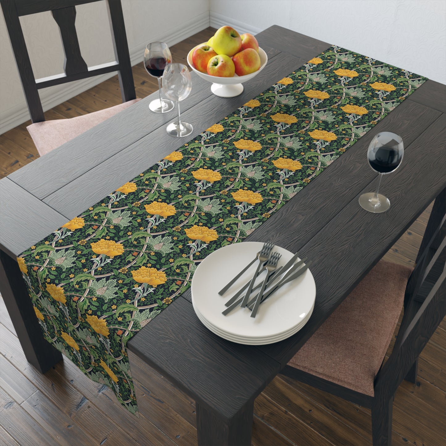 A yellow and green floral William Morris & Co patterned table runner with hemmed edges displayed on a dining table.