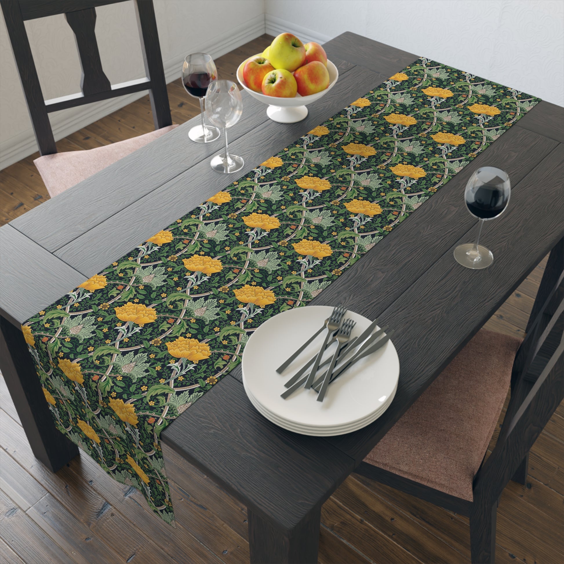 A yellow and green floral William Morris & Co patterned table runner with hemmed edges displayed on a dining table.