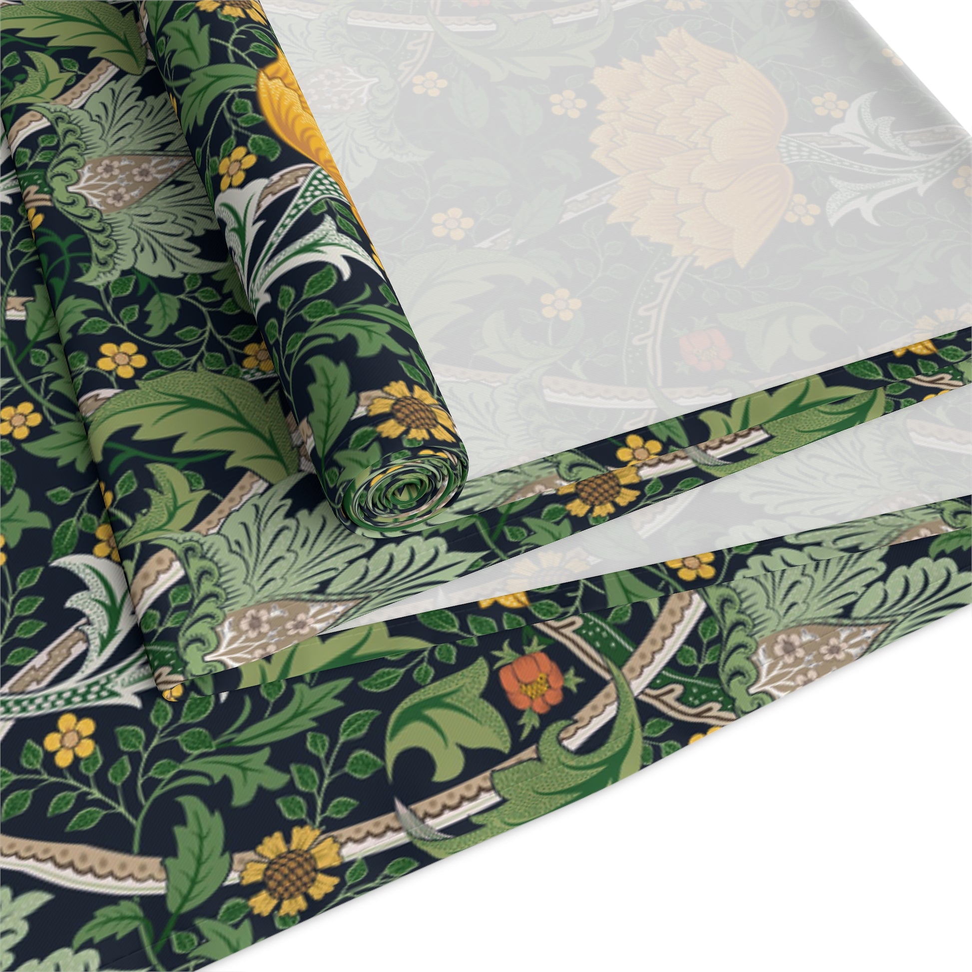 A yellow and green floral William Morris & Co patterned table runner with hemmed edges displayed on a dining table.