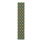 A yellow and green floral William Morris & Co patterned table runner with hemmed edges displayed on a dining table.