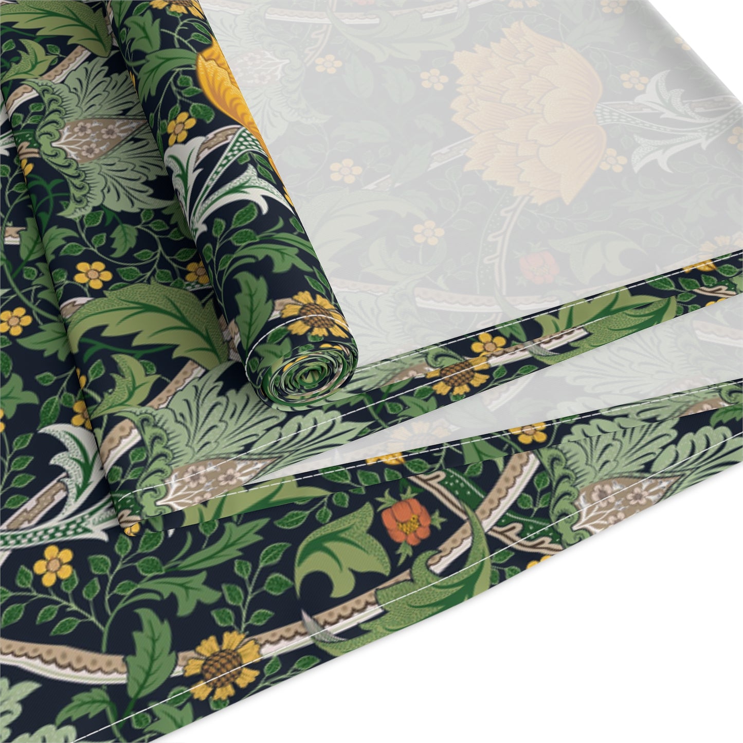 A yellow and green floral William Morris & Co patterned table runner with hemmed edges displayed on a dining table.