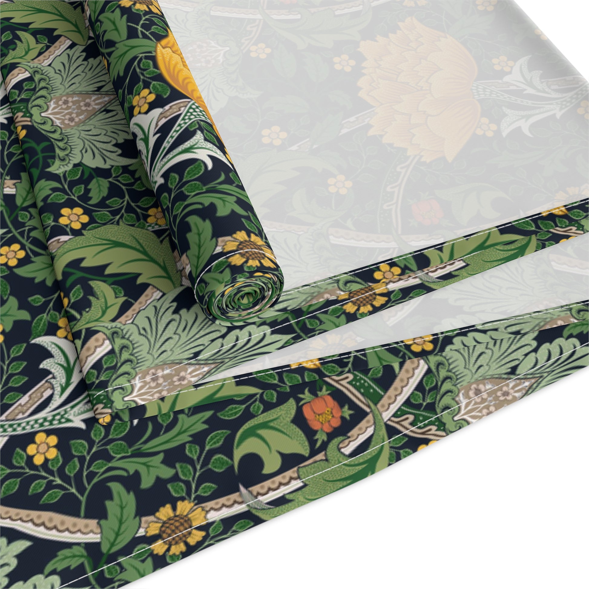 A yellow and green floral William Morris & Co patterned table runner with hemmed edges displayed on a dining table.