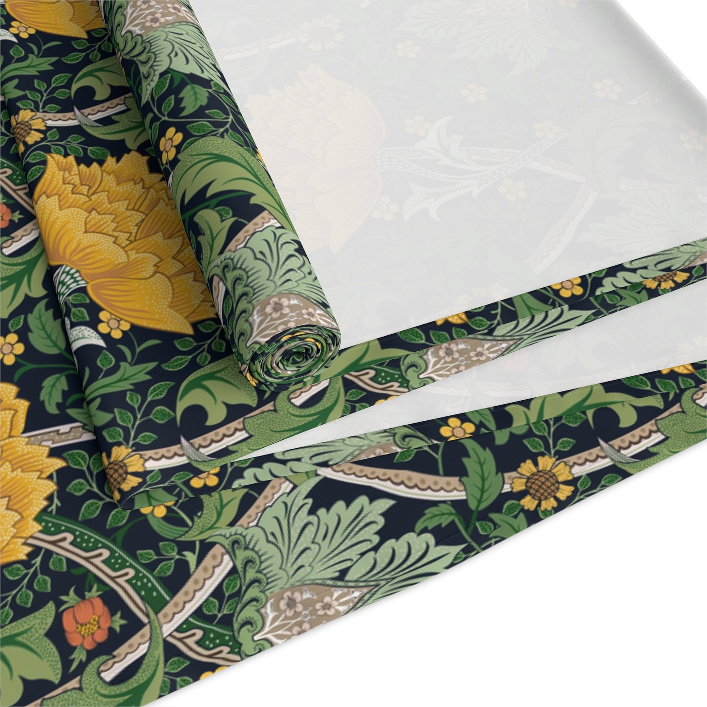 A yellow and green floral William Morris & Co patterned table runner with hemmed edges displayed on a dining table.