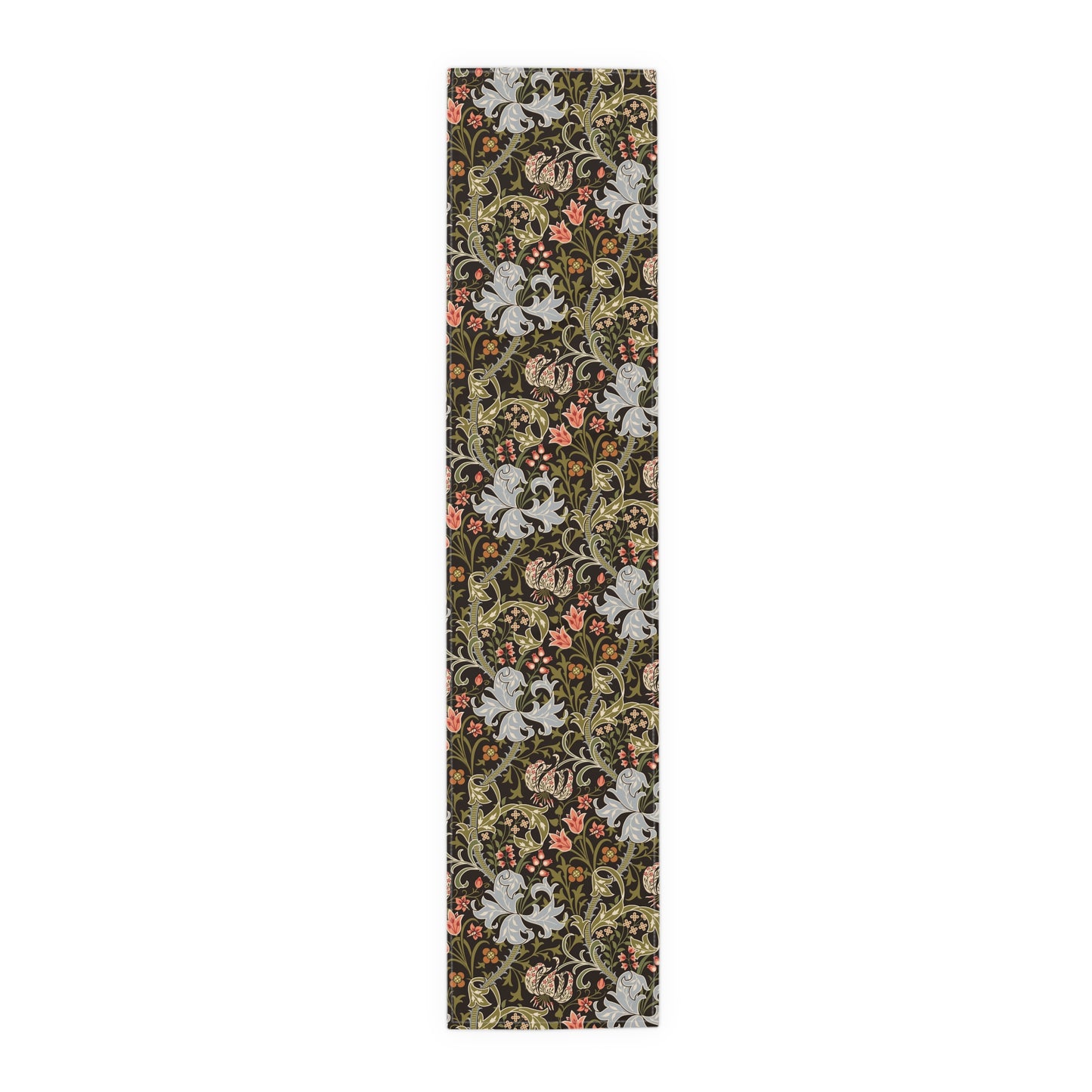 A table runner with a floral William Morris & Co pattern in shades of green, gold, and other colours, laid out on a dining table with dishes and glasses arranged on top.