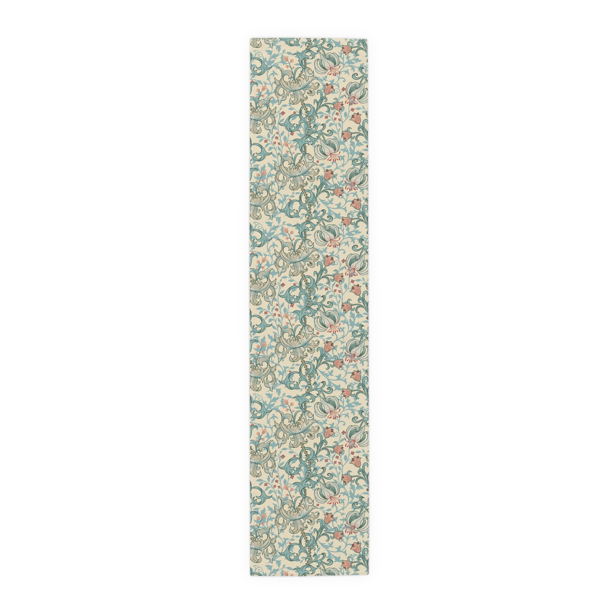 A table runner with a floral William Morris & Co pattern in green, beige, and gold colours, laid out on a dining table.