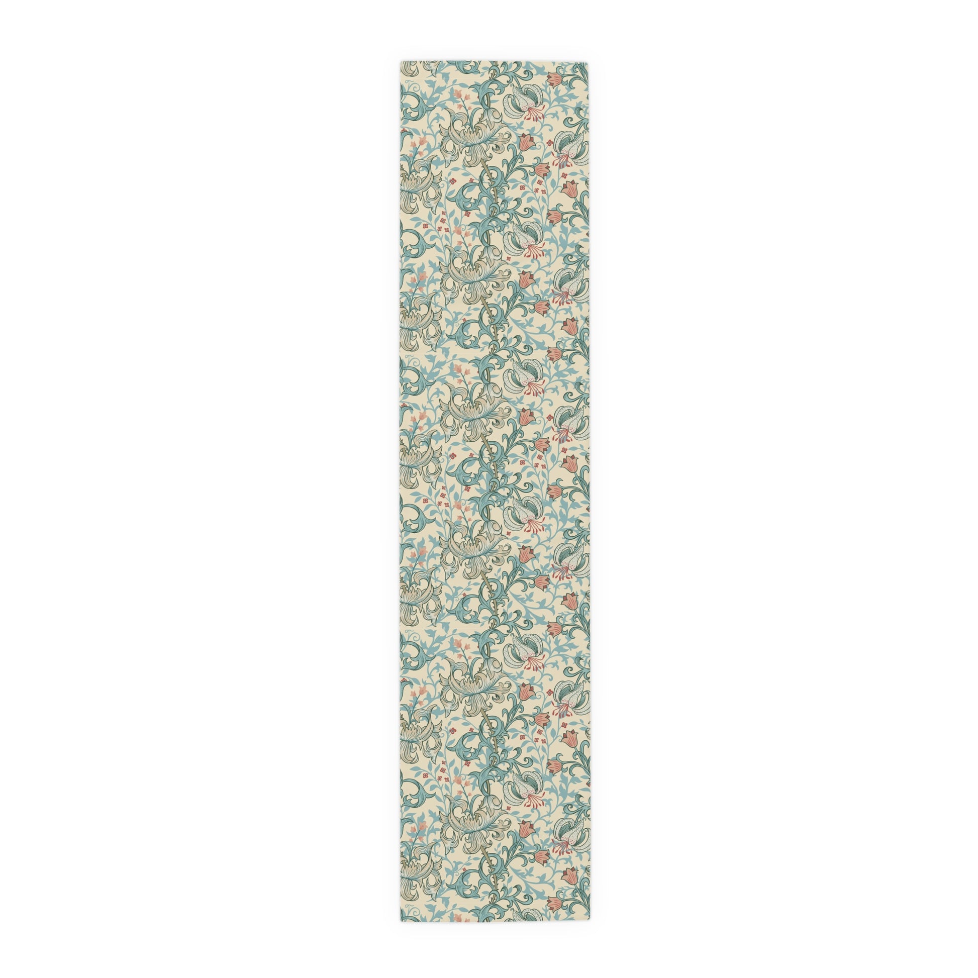 A table runner with a floral William Morris & Co pattern in green, beige, and gold colours, laid out on a dining table.