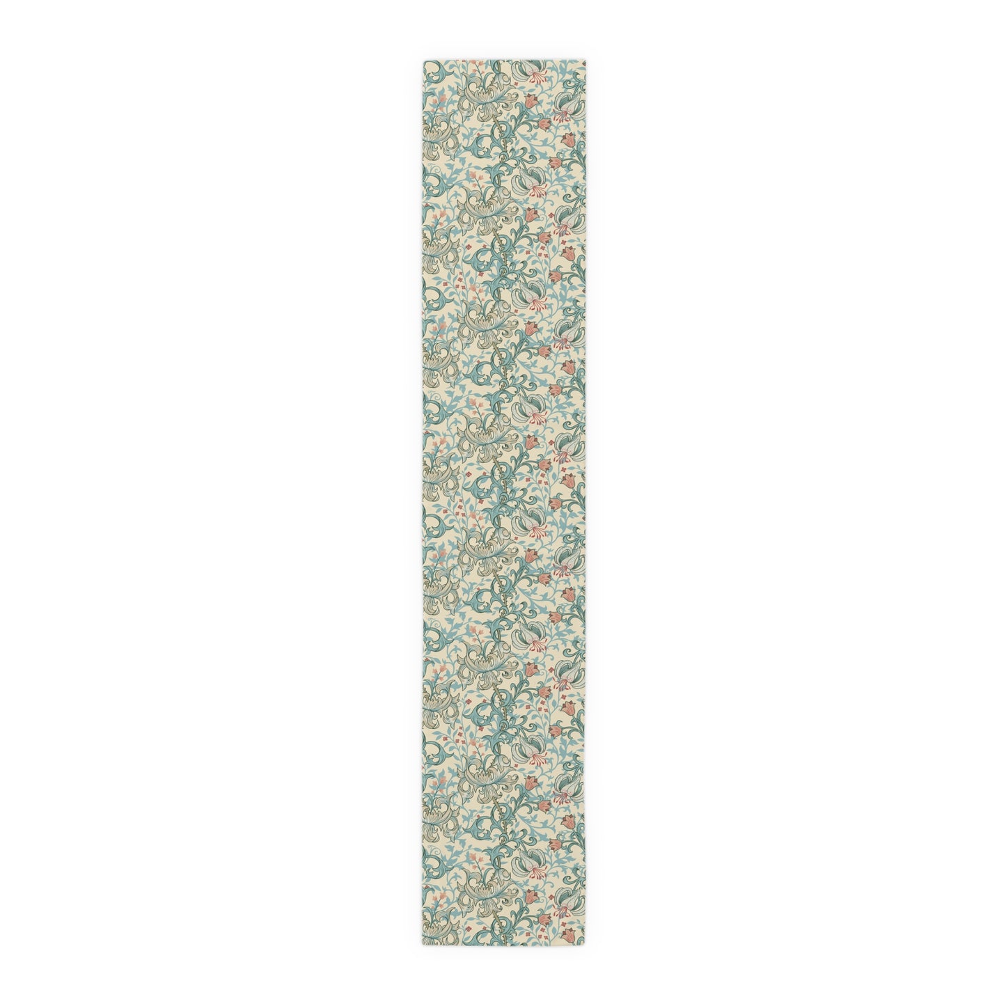 A table runner with a floral William Morris & Co pattern in green, beige, and gold colours, laid out on a dining table.