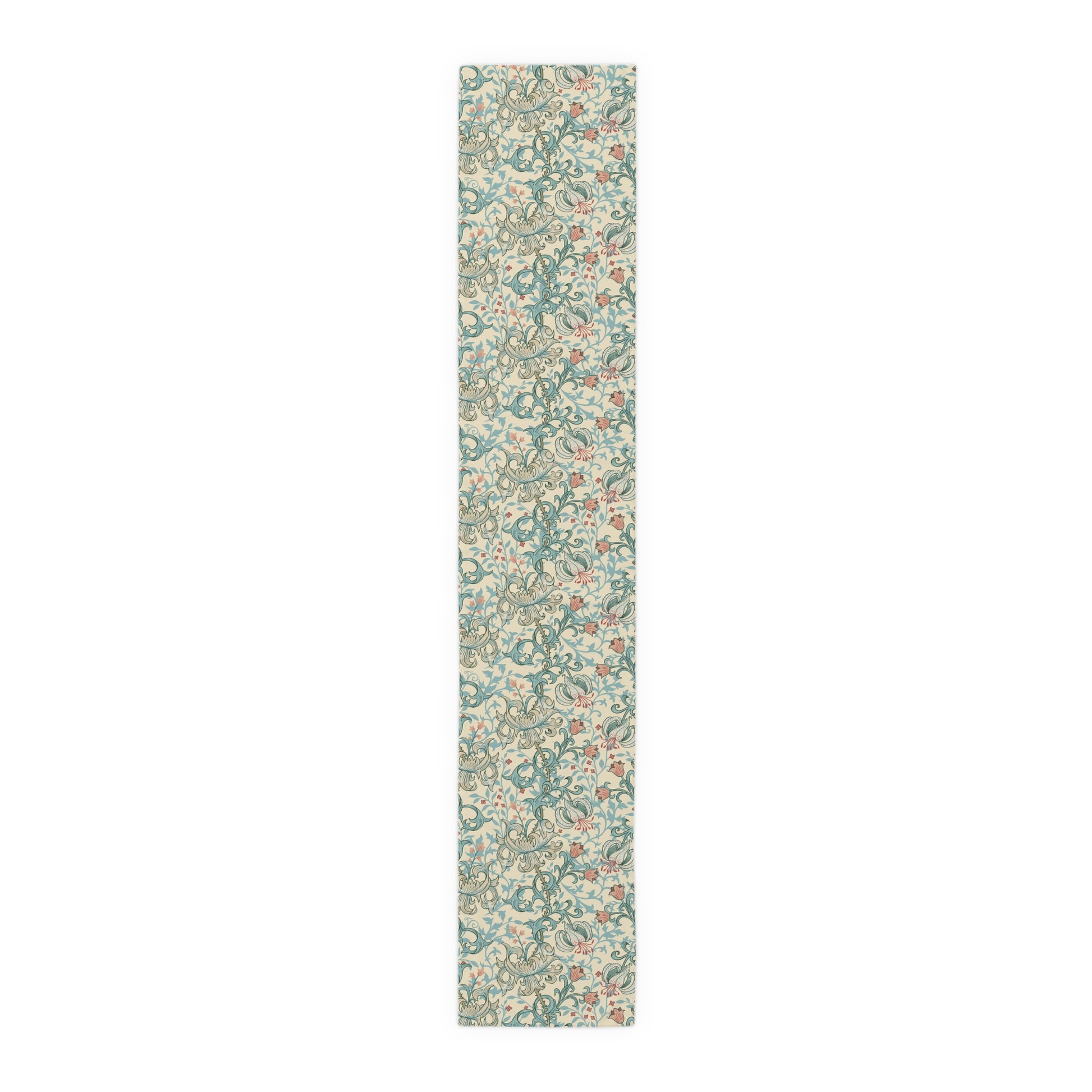 A table runner with a floral William Morris & Co pattern in green, beige, and gold colours, laid out on a dining table.