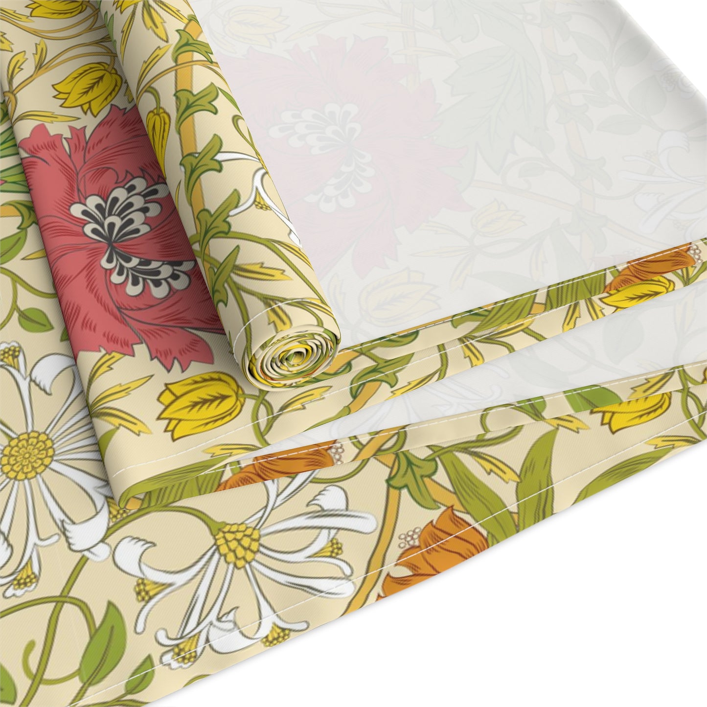 A table runner with a floral William Morris & Co pattern in red, green, and white colours, laid out on a dining table.