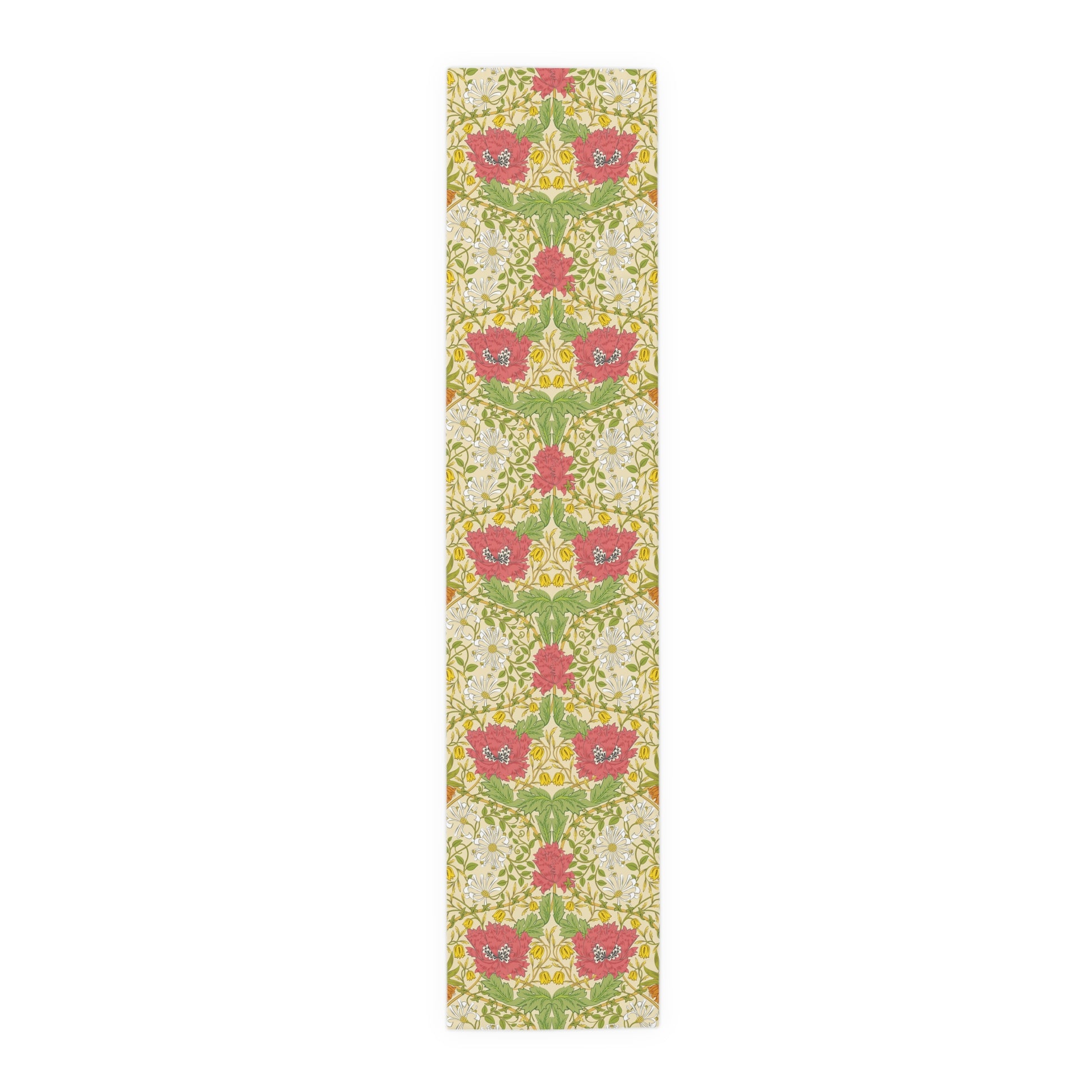 A table runner with a floral William Morris & Co pattern in red, green, and white colours, laid out on a dining table.