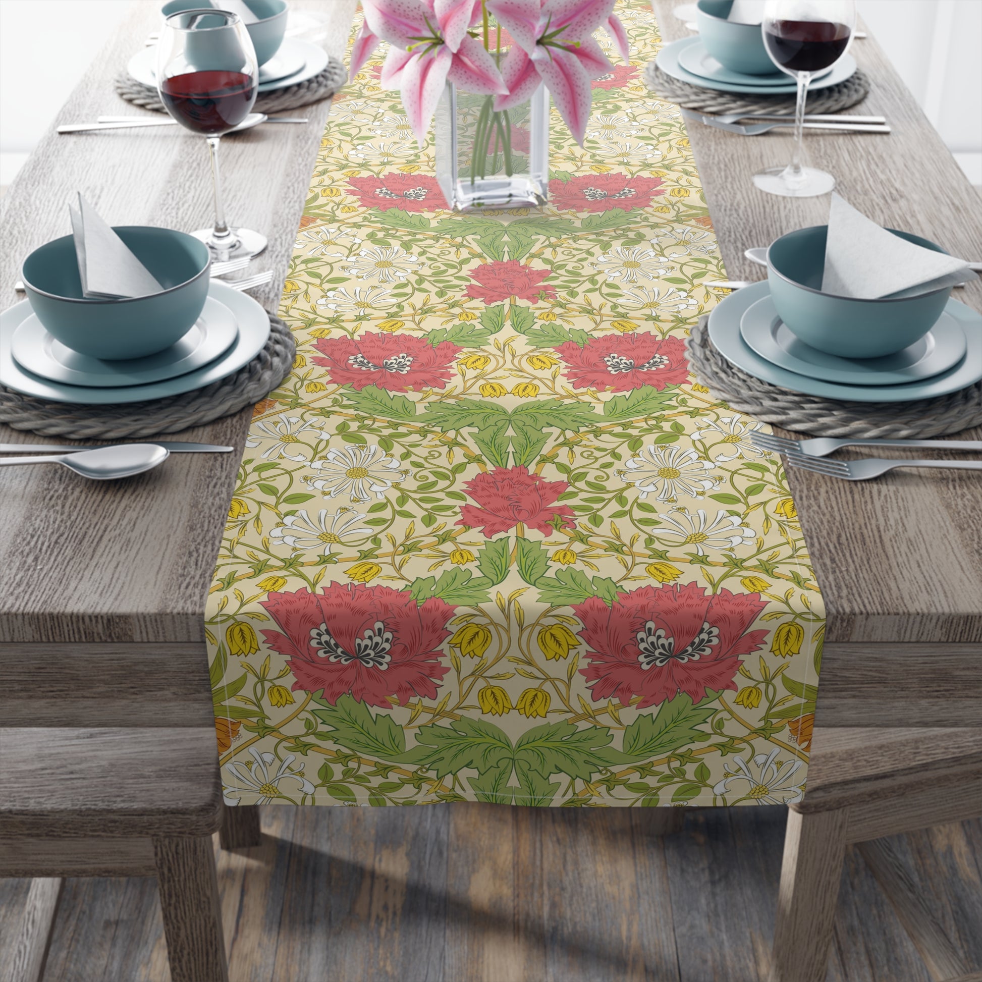 A table runner with a floral pattern in red, green, and white colors, laid out on a dining table.