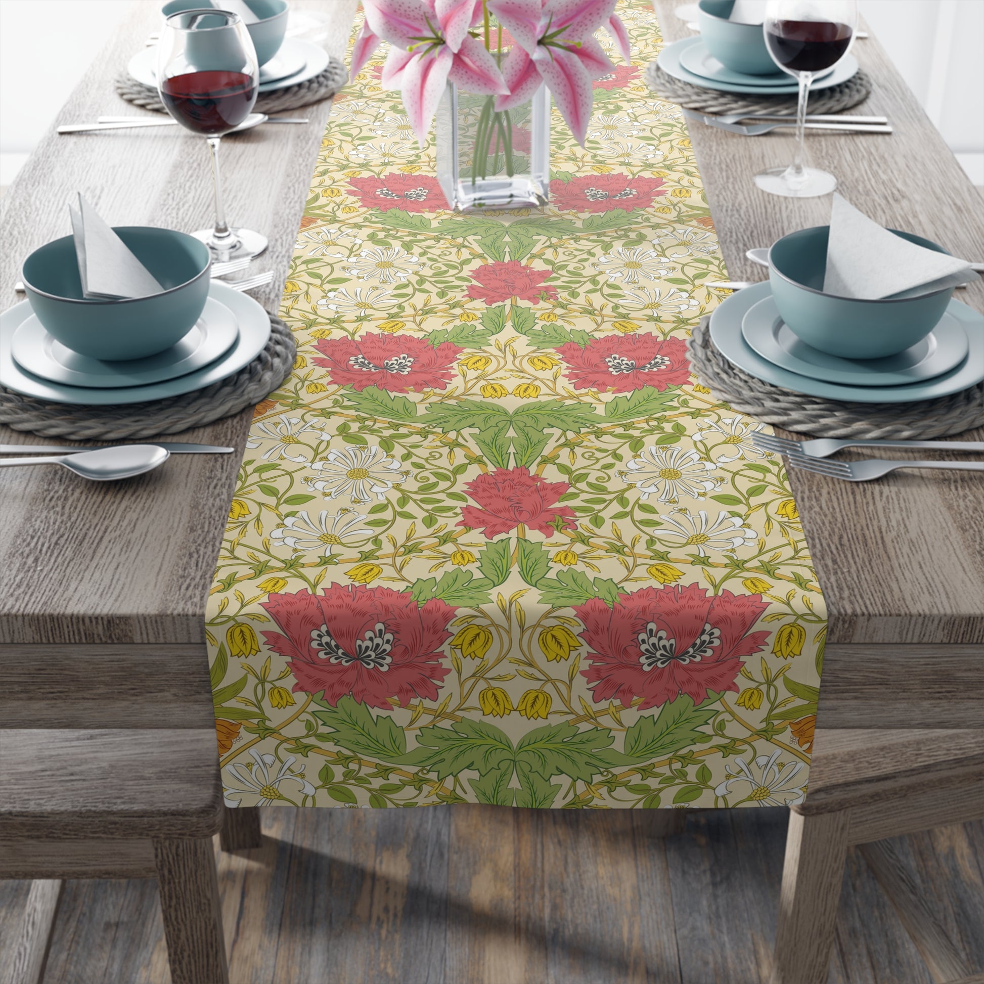 A table runner with a floral pattern in red, green, and white colors, laid out on a dining table.