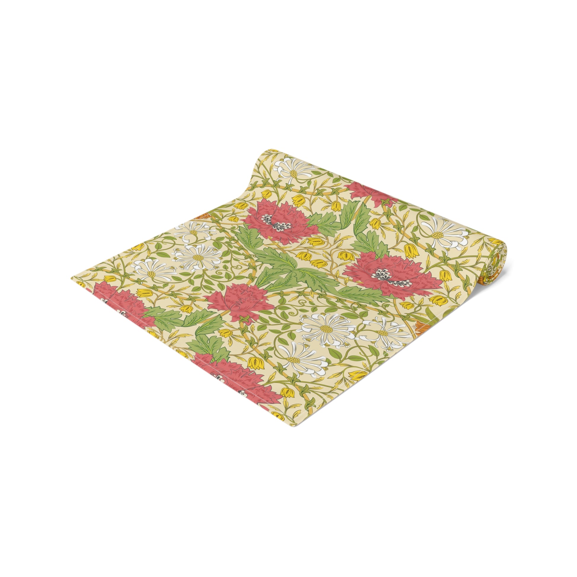 A table runner with a floral William Morris & Co pattern in red, green, and white colours, laid out on a dining table.